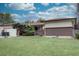 Ranch-style home with a well-maintained front yard, brick accents, and mature landscaping at 9584 W Kentucky Ave, Lakewood, CO 80226