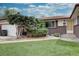 Close up of a ranch-style home with a well-maintained front yard and brick accents at 9584 W Kentucky Ave, Lakewood, CO 80226