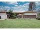 Ranch-style home with a well-maintained front yard, brick accents, and mature landscaping at 9584 W Kentucky Ave, Lakewood, CO 80226
