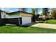 Attached two-car garage with a white door, brick accents, and a well-maintained green lawn at 9584 W Kentucky Ave, Lakewood, CO 80226