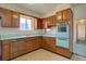 Retro kitchen with wooden cabinets, vintage appliances, and mint green countertops at 9584 W Kentucky Ave, Lakewood, CO 80226