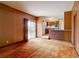 Cozy living area featuring a kitchen view, a brick counter, and wood-paneled walls at 9584 W Kentucky Ave, Lakewood, CO 80226