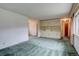 Open living room with built-in shelving, large window, and neutral color scheme at 9584 W Kentucky Ave, Lakewood, CO 80226