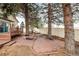 Brick patio, fire pit and mature trees at 11997 W Coal Mine Dr, Littleton, CO 80127