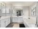 Bathroom with double vanity and a jetted tub at 11997 W Coal Mine Dr, Littleton, CO 80127