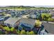 Aerial view showing backyard patio with fire pit, landscaped yard, and houses in the neighborhood at 6616 Amur Ln, Castle Rock, CO 80108