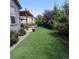 Green backyard featuring artificial turf and a pergola with an adjacent patio at 6616 Amur Ln, Castle Rock, CO 80108