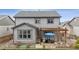 Two-story home featuring backyard patio with a pergola, stone fire pit and green landscaping at 6616 Amur Ln, Castle Rock, CO 80108