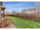 Grassy backyard featuring artificial turf and a fence at 6616 Amur Ln, Castle Rock, CO 80108