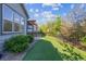 Backyard showing artificial turf, manicured landscaping, fire pit under a pergola, and patio seating at 6616 Amur Ln, Castle Rock, CO 80108