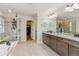 Luxurious bathroom with a glass shower, soaking tub, and granite countertops at 6616 Amur Ln, Castle Rock, CO 80108