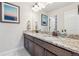 Elegant bathroom featuring double sinks, granite countertops, and modern fixtures at 6616 Amur Ln, Castle Rock, CO 80108