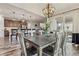 Dining room with large windows, access to the backyard, and a modern chandelier at 6616 Amur Ln, Castle Rock, CO 80108