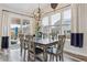 Dining room with large windows, access to the backyard, and a modern chandelier at 6616 Amur Ln, Castle Rock, CO 80108