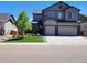 Charming two-story home with a well-maintained front yard, two-car garage, and beautiful curb appeal at 6616 Amur Ln, Castle Rock, CO 80108