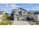 Charming two-story home with a well-maintained lawn and a three-car garage at 6616 Amur Ln, Castle Rock, CO 80108
