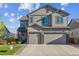 Charming two-story home with a well-manicured lawn and two-car garage on a sunny day at 6616 Amur Ln, Castle Rock, CO 80108