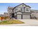 Charming two-story home with a two car garage and a well-maintained front yard at 6616 Amur Ln, Castle Rock, CO 80108