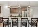 Stylish kitchen island with pendant lighting and seating for four at 6616 Amur Ln, Castle Rock, CO 80108