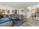 Open-concept living room with hardwood floors, modern furnishings, and seamless flow to the kitchen at 6616 Amur Ln, Castle Rock, CO 80108