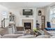 Cozy living room with a fireplace, comfortable seating, and hardwood floors at 6616 Amur Ln, Castle Rock, CO 80108
