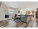 Bright living room featuring hardwood floors and a large sectional couch at 6616 Amur Ln, Castle Rock, CO 80108