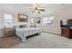Comfortable main bedroom with a ceiling fan and large windows for natural light at 6616 Amur Ln, Castle Rock, CO 80108