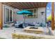 Outdoor patio features a stone fire pit, comfortable seating, and a stylish pergola for relaxing at 6616 Amur Ln, Castle Rock, CO 80108