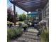 Outdoor patio with a pergola, seating, and a view of the landscaped backyard at 6616 Amur Ln, Castle Rock, CO 80108