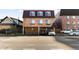 Brick building exterior with parking in front and additional parking behind the building at 36 N Emerson St # 203, Denver, CO 80218