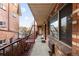 Exterior hallway with brick walls and metal railings at 36 N Emerson St # 203, Denver, CO 80218