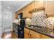 Bright kitchen with stainless steel appliances and a view into the bathroom at 36 N Emerson St # 203, Denver, CO 80218