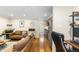 Living room with brown couch, wood floors, and an open floor plan at 36 N Emerson St # 203, Denver, CO 80218