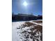 Brick ranch home with a yard, partially covered in snow at 1240 Russell Blvd, Thornton, CO 80229