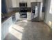 Modern kitchen with stainless steel appliances and granite countertops at 1240 Russell Blvd, Thornton, CO 80229