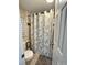 Bathroom showcasing a toilet and stylish shower curtain at 7115 Harold St # 2, Fort Lupton, CO 80621