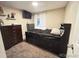 Carpeted bedroom with dark furniture, a window and a wall-mounted television at 7115 Harold St # 2, Fort Lupton, CO 80621
