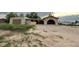 Ranch-style home with a unique arched carport and a spacious gravel driveway at 7115 Harold St # 2, Fort Lupton, CO 80621