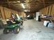 Spacious garage with ample storage and organization, featuring a lawn mower at 7115 Harold St # 2, Fort Lupton, CO 80621