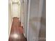 Hallway features wood laminate flooring and multiple storage closets at 7115 Harold St # 2, Fort Lupton, CO 80621