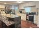 Updated kitchen features granite countertops, stainless steel appliances, and modern white cabinets at 7115 Harold St # 2, Fort Lupton, CO 80621