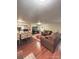 Open-concept living room flows into the kitchen, featuring wood floors and comfortable seating at 7115 Harold St # 2, Fort Lupton, CO 80621