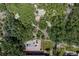 Aerial view of a backyard featuring a playground, lush trees, and a patio for entertaining at 452 Gordon Dr, Castle Rock, CO 80104