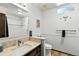 Well-lit bathroom featuring a granite countertop, shower with white tile, and a built-in toilet at 452 Gordon Dr, Castle Rock, CO 80104
