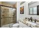 Updated bathroom featuring tiled shower with glass door and granite countertop, offering modern elegance at 452 Gordon Dr, Castle Rock, CO 80104