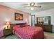 Cozy bedroom featuring wood furniture, a ceiling fan, and decorative artwork, creating a relaxing space at 452 Gordon Dr, Castle Rock, CO 80104