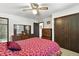 Comfortable bedroom with a ceiling fan, wood dresser with mirror, and access to the bathroom at 452 Gordon Dr, Castle Rock, CO 80104