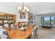 Beautiful dining room featuring a stylish chandelier and seamless flow to living spaces and fireplace at 452 Gordon Dr, Castle Rock, CO 80104