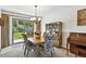 Elegant dining room featuring a chandelier, sliding glass doors, and stylish furniture at 452 Gordon Dr, Castle Rock, CO 80104