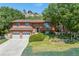 Charming two-story home featuring a well-manicured lawn, mature trees, and a two-car garage at 452 Gordon Dr, Castle Rock, CO 80104